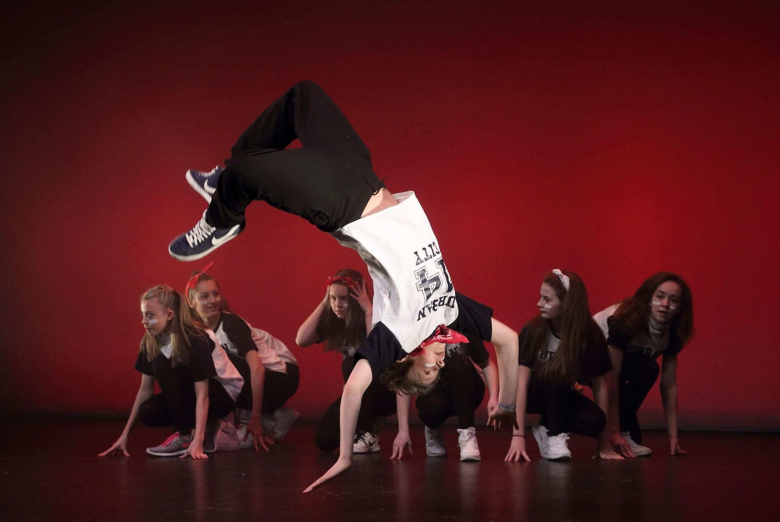 A dance student performs a back flip while the other East Grinstead dancers get ready to spring in to action at the Hawth in Crawley